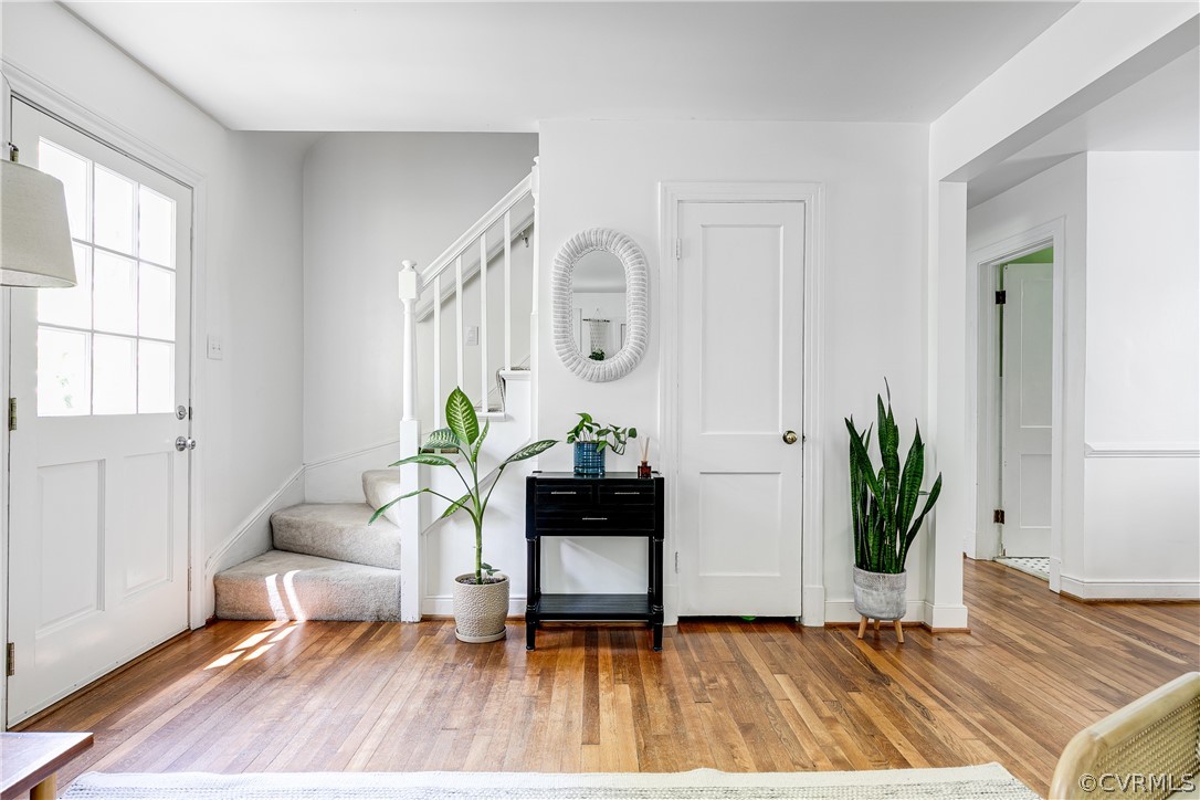 8934 Elm Road Richmond, VA 23235 - Photo 4 of 37 a living room with wooden floor and a potted plant