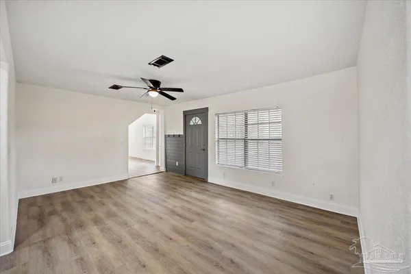 wooden floor in an empty room with a window