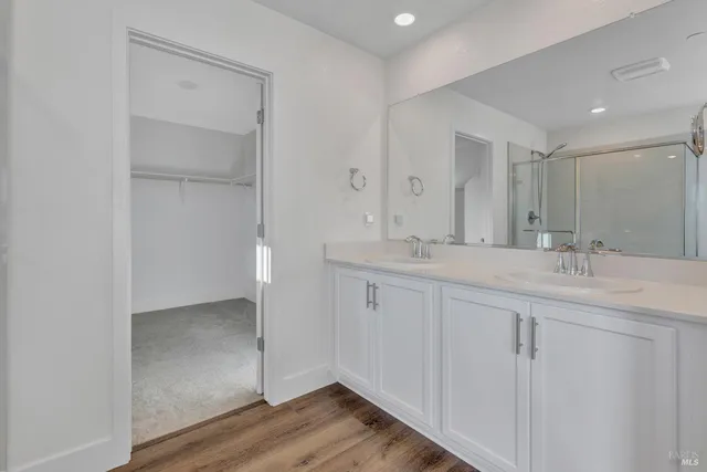 a bathroom with a double vanity sink and a mirror