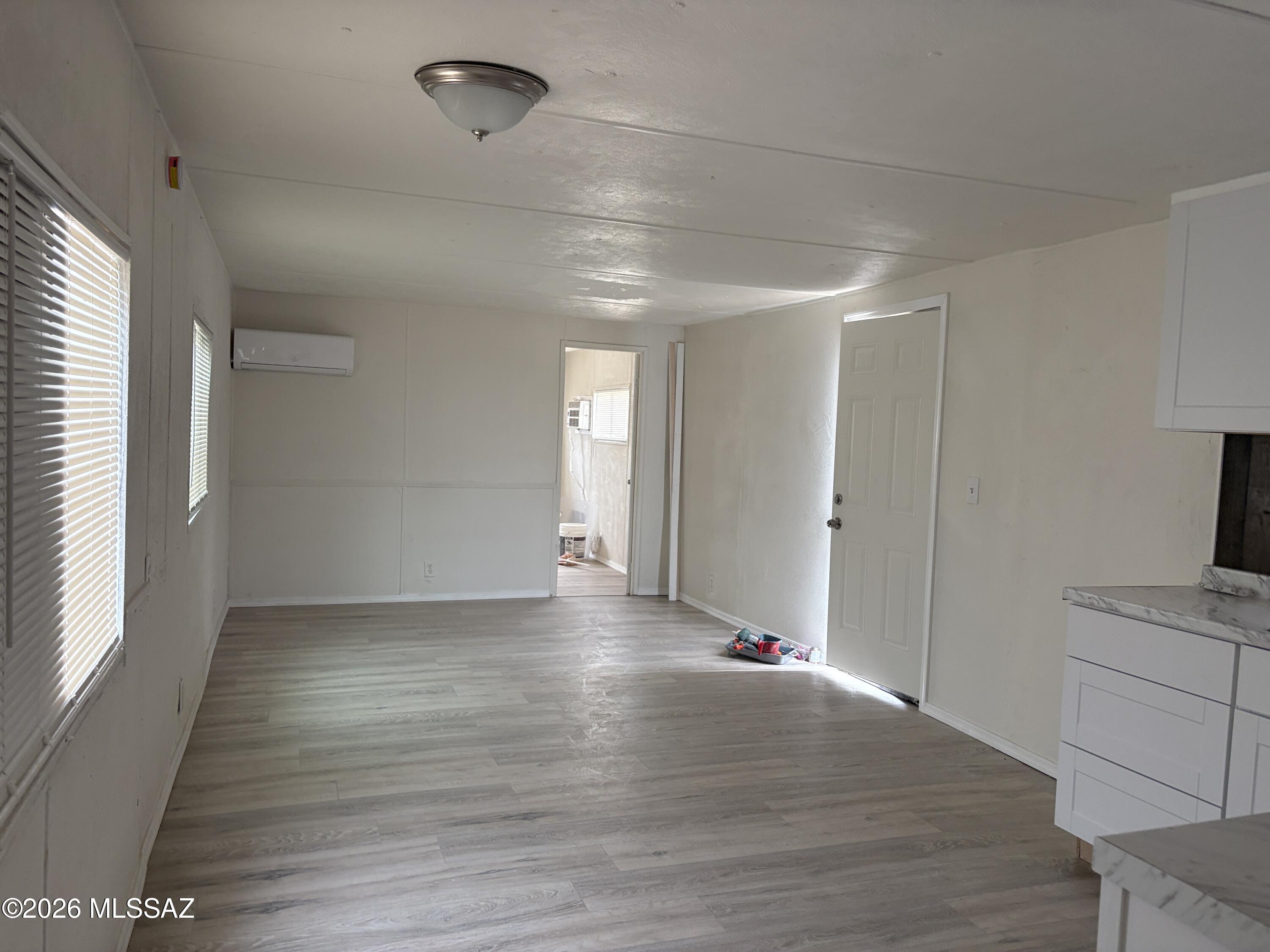 1741 West Wetmore Road, Unit 17 Tucson, AZ 85705 - Photo 9 of 9 a view of an empty room with window and wooden floor
