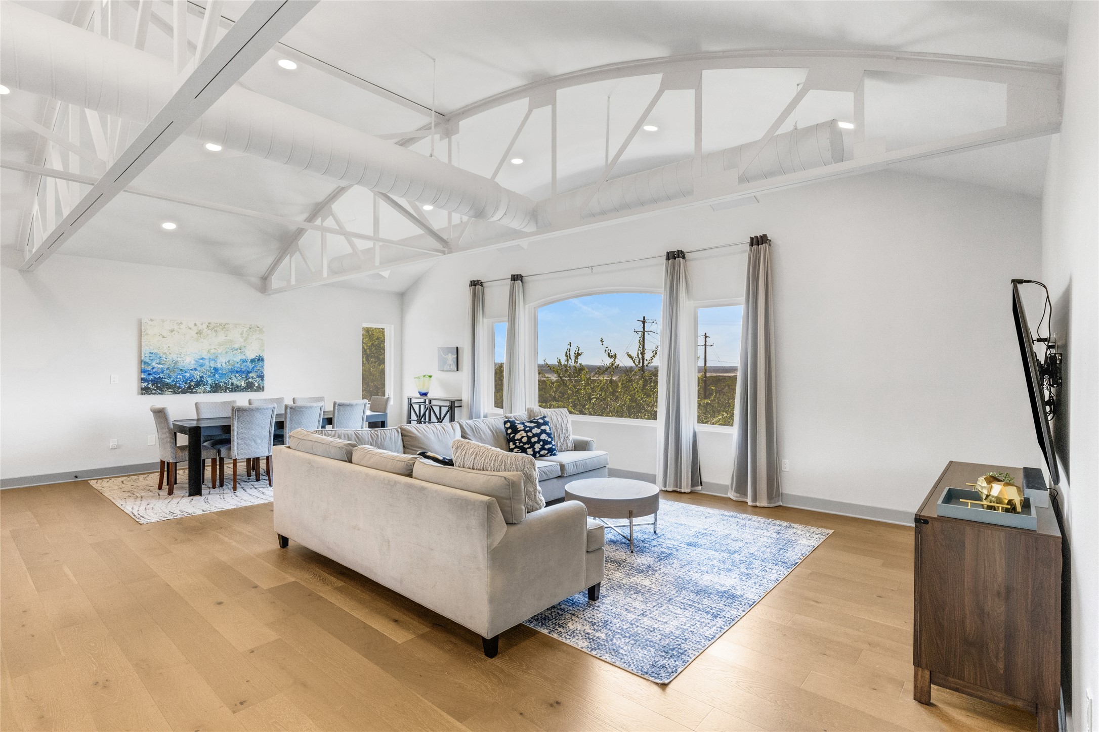 4227 Eck Lane Austin, TX 78734 - Photo 11 of 30 Living area featuring light wood finished floors and vaulted ceiling