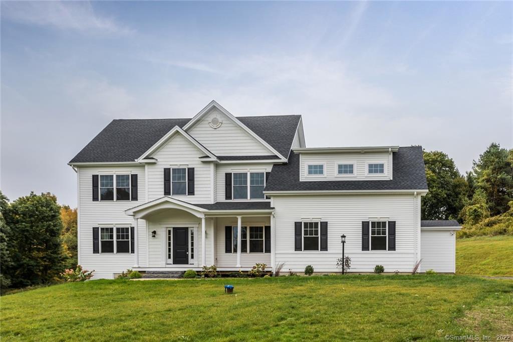59 B Hattertown Road Newtown, CT 06470 - Photo 1 of 1 a front view of a house with a yard and trees
