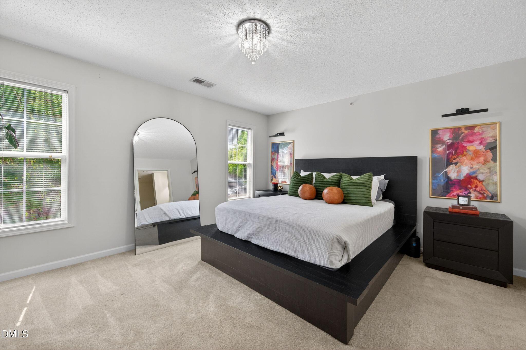 2400 Huntscroft Lane, Unit 202 Raleigh, NC 27617 - Photo 19 of 49 a bedroom with a large bed and a window
