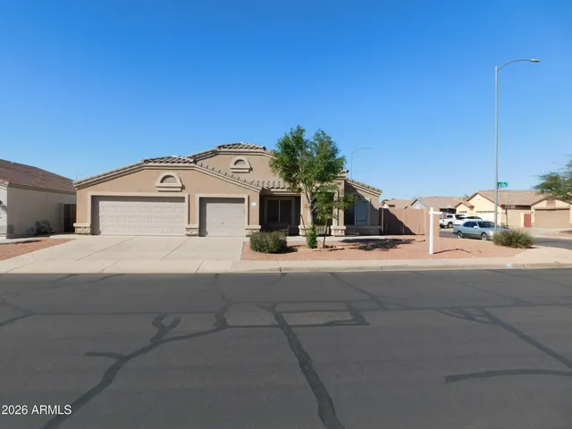 a view of a white house with a street