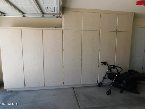 a view of storage and utility room with closet dryer and washer