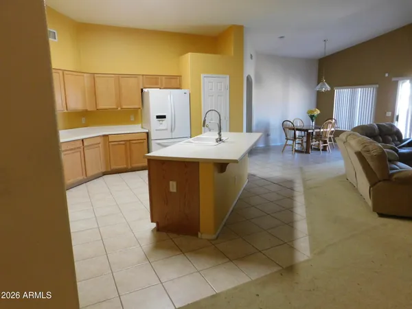 a kitchen that has a sink and a refrigerator