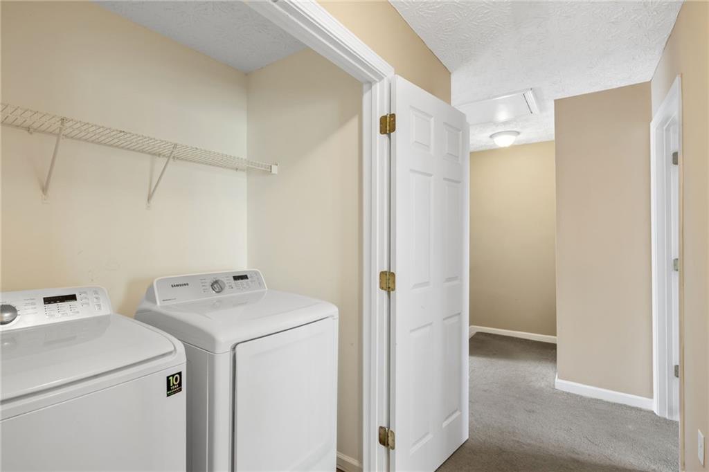 1558 Paramount View Trace Northeast Sugar Hill, GA 30518 - Photo 19 of 21 a utility room with dryer and washer