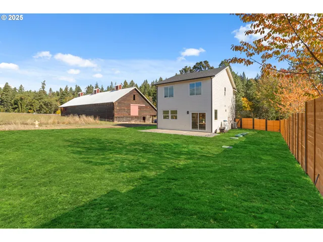 a view of a house with a yard and sitting area