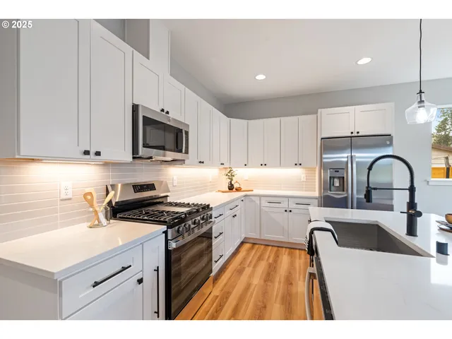 a kitchen that has a sink and a stove in it