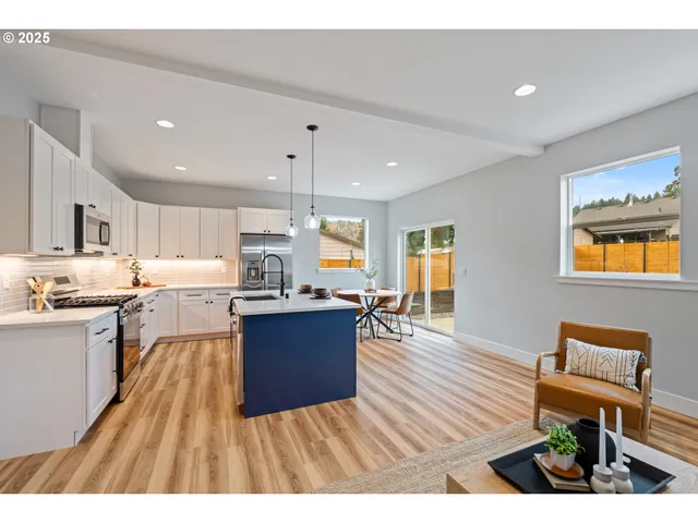 a kitchen with stainless steel appliances granite countertop a refrigerator a stove top oven a sink dishwasher and wooden cabinets with wooden floor