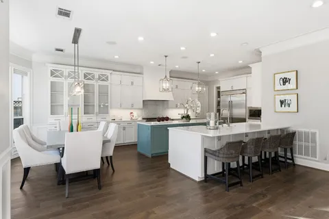 a large kitchen with a table and chairs