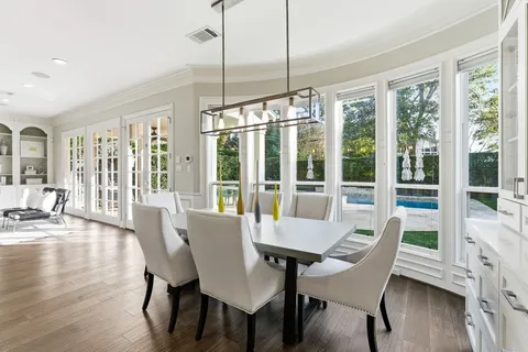 a view of a dining room with furniture window and wooden floor