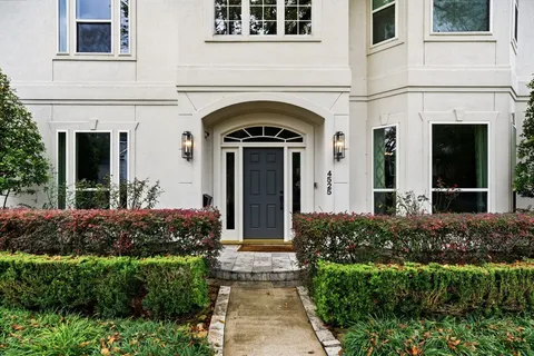 front view of a house with potted plants