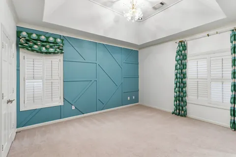 an empty room with windows and entrance