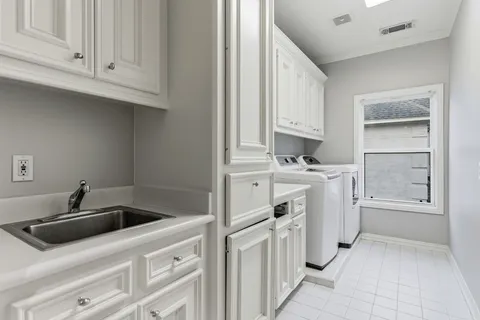 a kitchen with white cabinets and white appliances