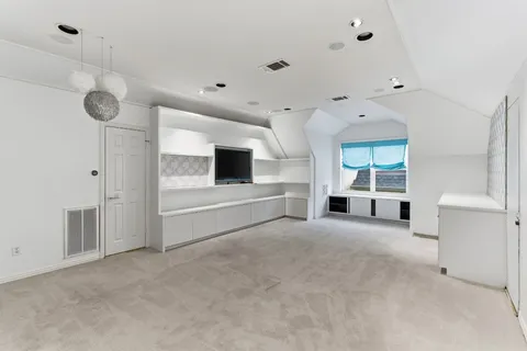 a view of an empty room with a kitchen