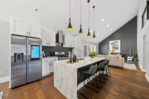 a dining room with furniture a flat screen tv and a fireplace