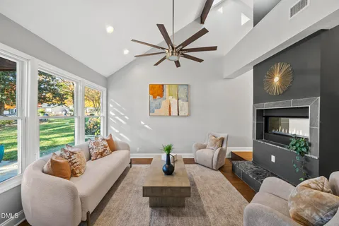 a living room with furniture and a wooden floor