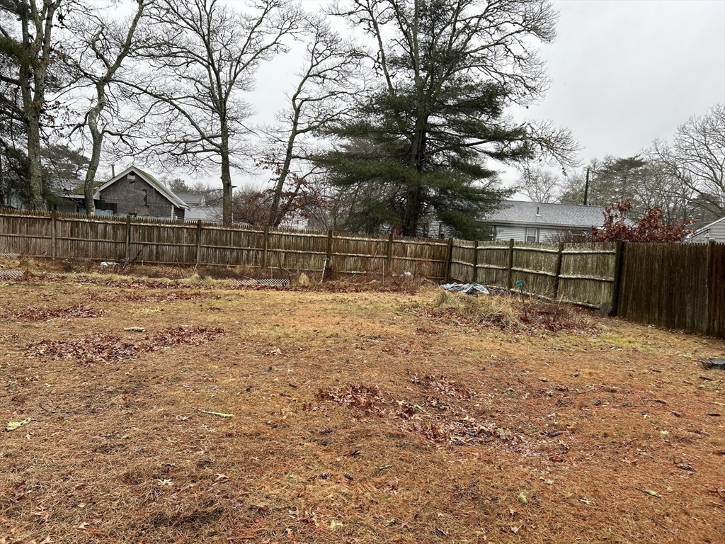 58 Cohasset Road Wareham, MA 02532 - Photo 11 of 14 a view of a yard with wooden fence