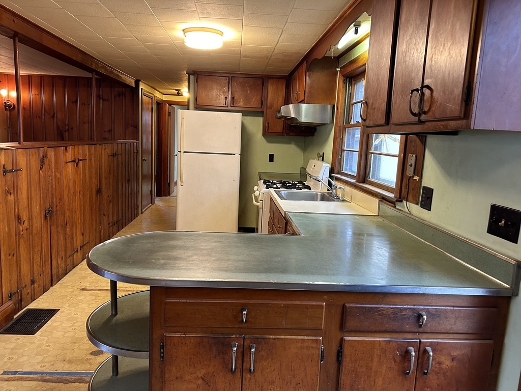 58 Cohasset Road Wareham, MA 02532 - Photo 2 of 14 a view of a refrigerator a table and chairs in a room