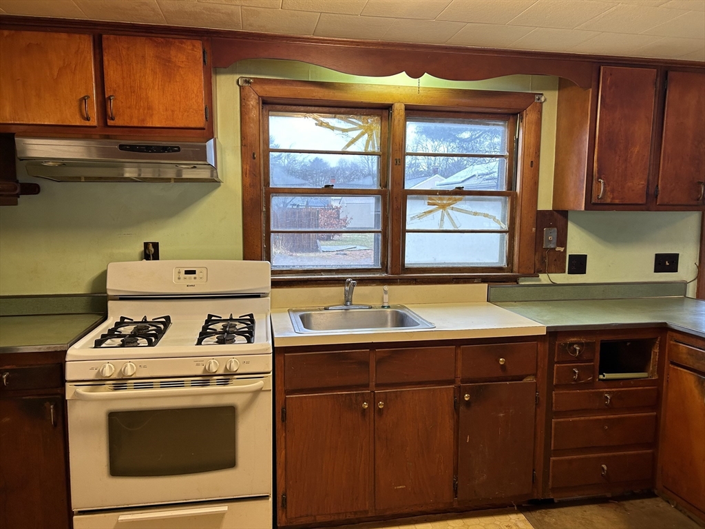 58 Cohasset Road Wareham, MA 02532 - Photo 3 of 14 a kitchen with a stove and a sink