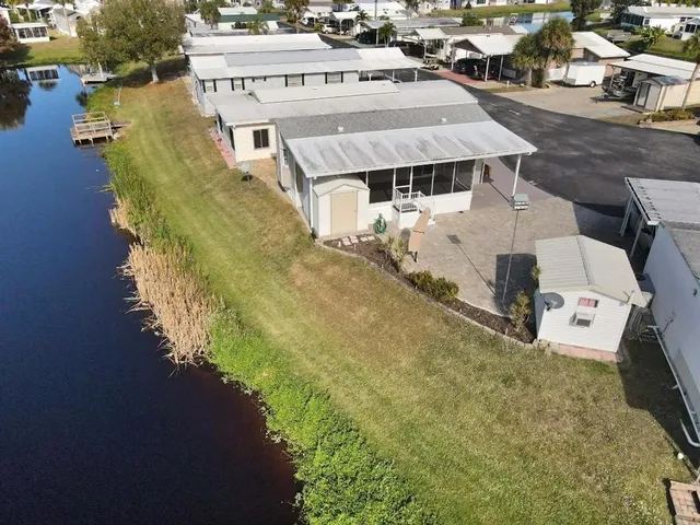 an aerial view of a house with a yard basket ball court and outdoor seating