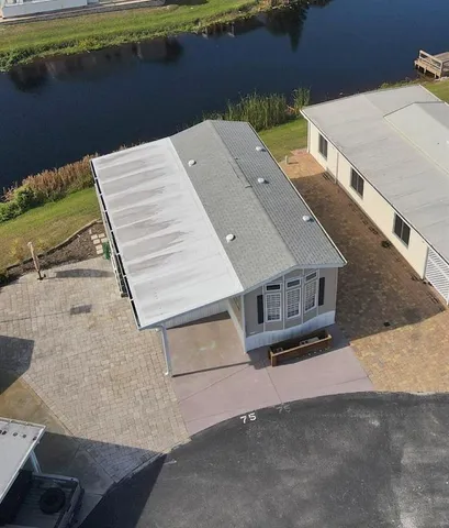 an aerial view of a house with a yard