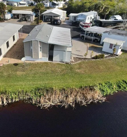 a aerial view of a house with a garden and lake view