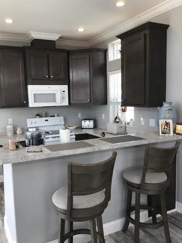 a kitchen with a sink cabinets and window