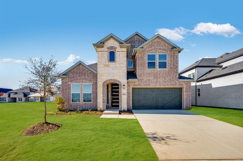 a front view of a house with a garden and yard