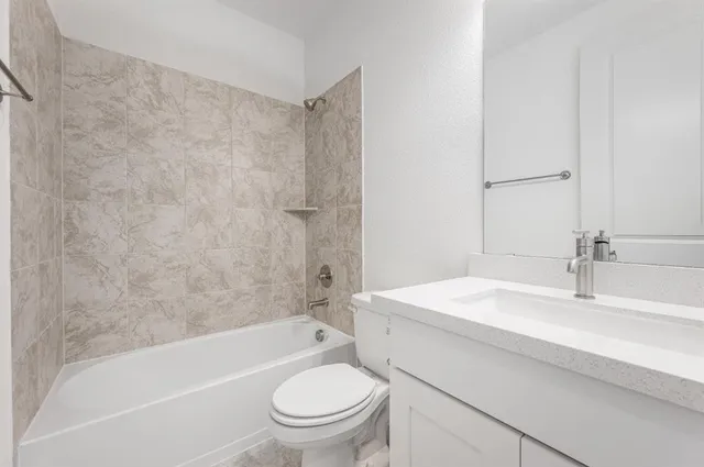 a bathroom with a sink a toilet and a bathtub