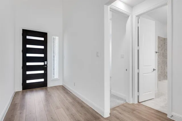 a view of front door with wooden floor