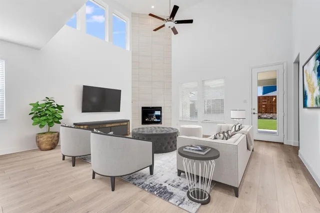 a living room with furniture potted plant and a flat screen tv
