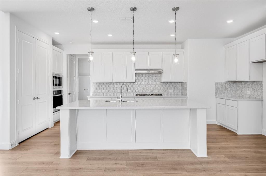 526 Chatham Street Oak Point, TX 75068 - Photo 6 of 35 a large kitchen with cabinets and wooden floor