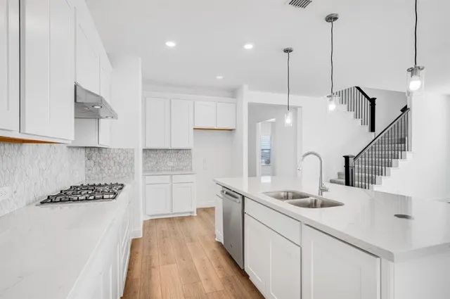 a kitchen with counter top space cabinets and appliances