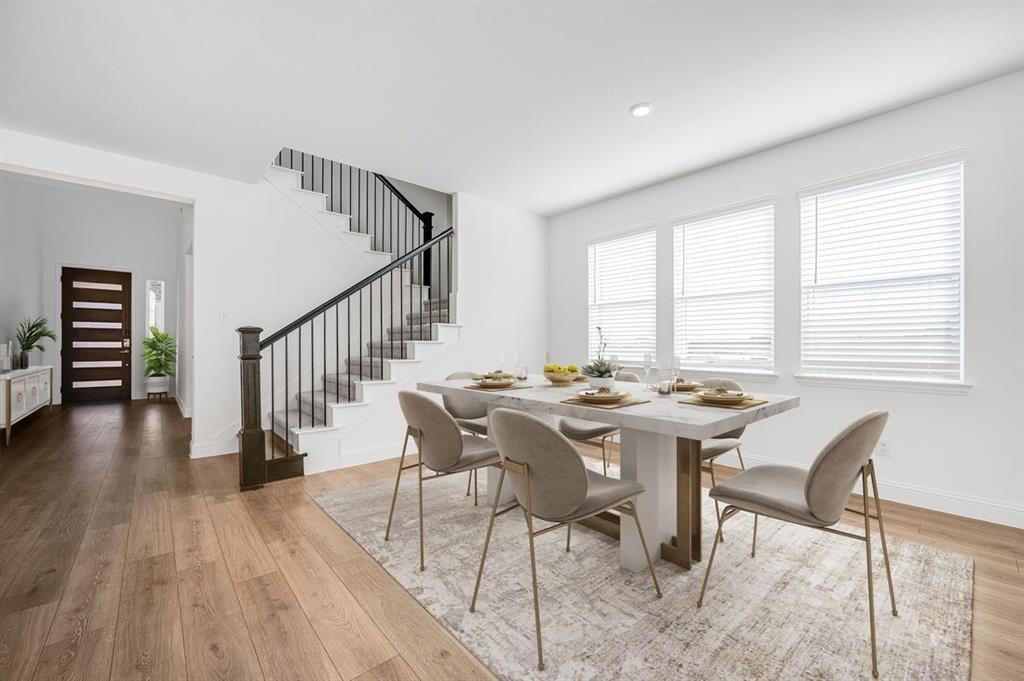 526 Chatham Street Oak Point, TX 75068 - Photo 9 of 35 a view of a dining room with furniture window and wooden floor