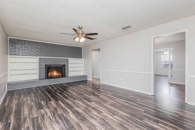 wooden floor in an empty room with a fireplace