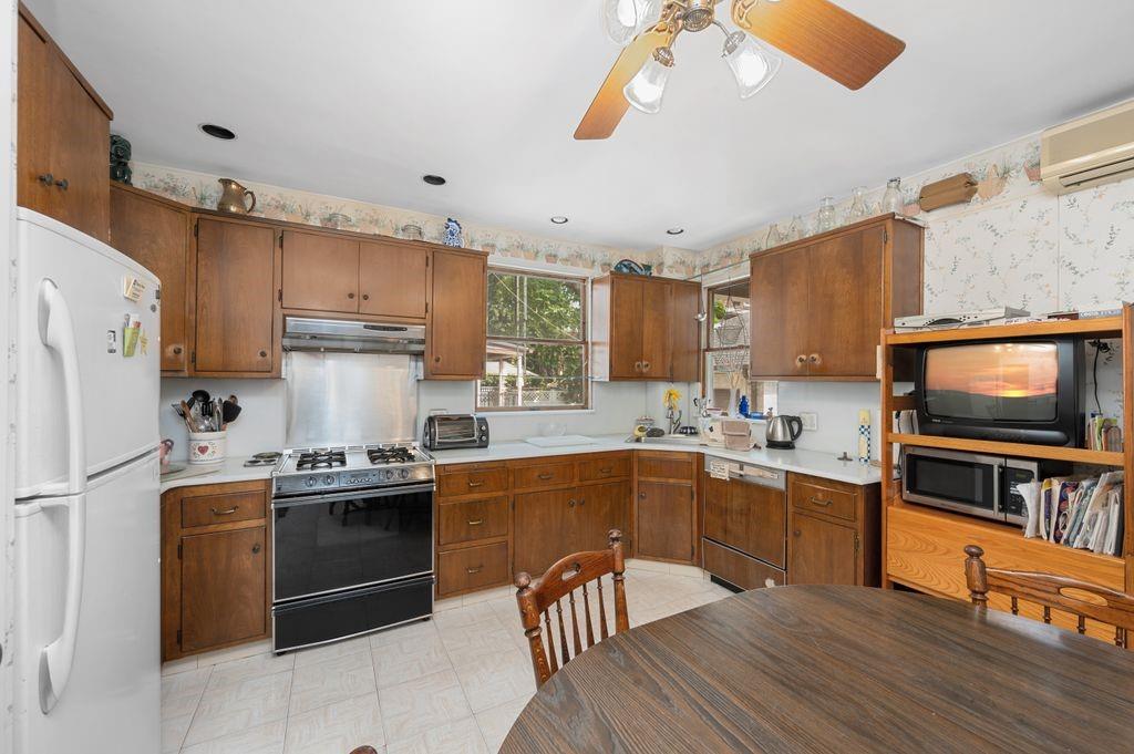 475 Argyle Road Brooklyn, NY 11218 - Photo 15 of 35 a kitchen with stainless steel appliances granite countertop a stove top oven a refrigerator a sink and dishwasher with wooden floor
