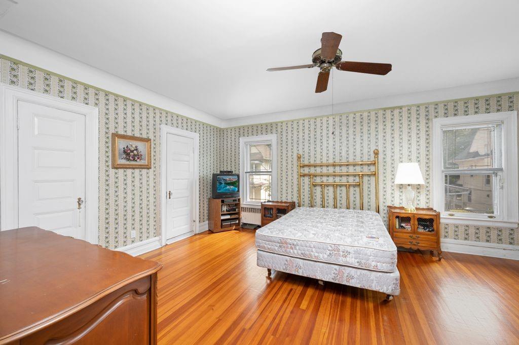 475 Argyle Road Brooklyn, NY 11218 - Photo 17 of 35 a bedroom with a bed and wooden floor