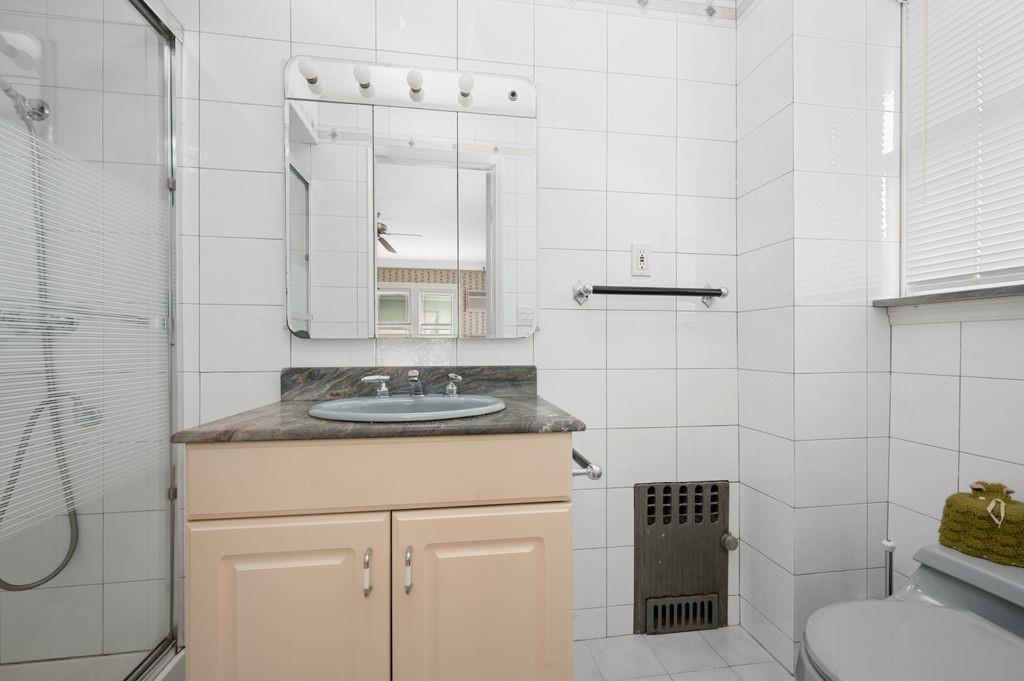 475 Argyle Road Brooklyn, NY 11218 - Photo 19 of 35 a bathroom with a granite countertop sink toilet and shower