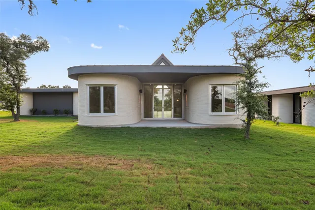 a front view of a house with a garden