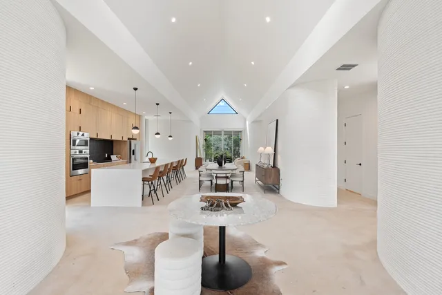 a living room with furniture a window and kitchen view