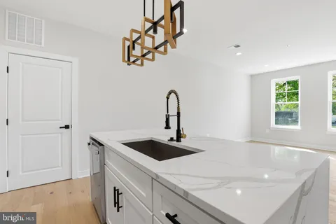 a close view of a sink a counter space and a window