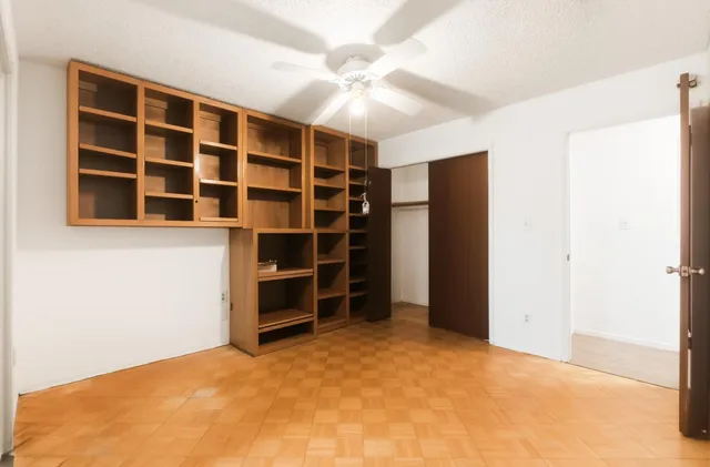 a view of an empty room with a closet
