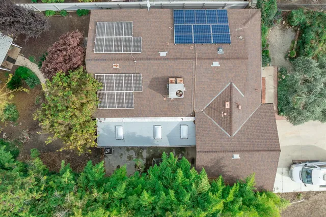 an aerial view of a house with a yard and potted plants