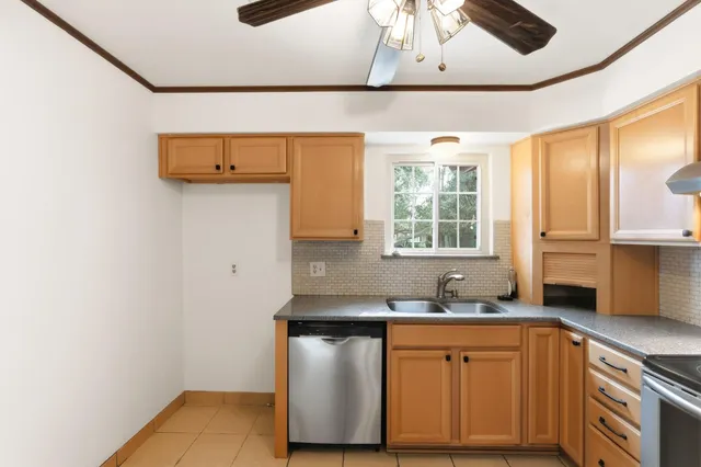 a kitchen with stainless steel appliances a sink stove and cabinets