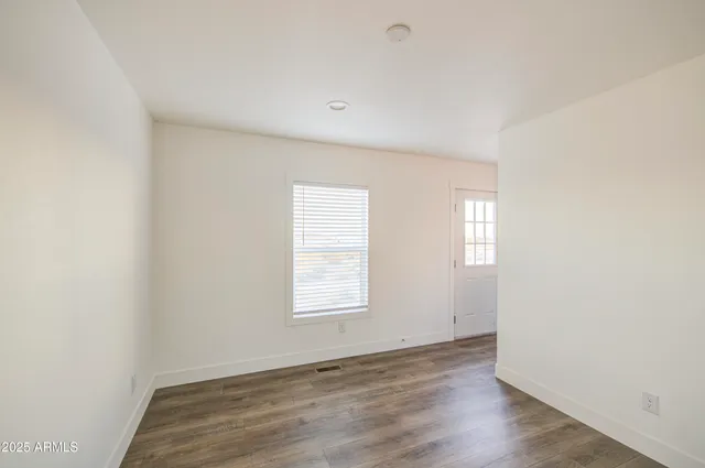 a view of a room with wooden floor and brick walls