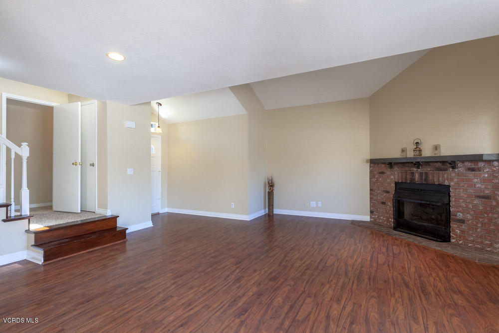 1990 Rory Lane, Unit 3 Simi Valley, CA 93063 - Photo 2 of 22 a view of a livingroom with wooden floor and a fireplace
