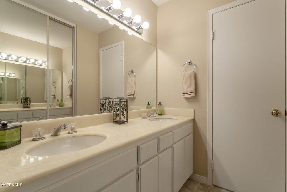 1990 Rory Lane, Unit 3 Simi Valley, CA 93063 - Photo 13 of 22 a bathroom with a double vanity sink and a mirror