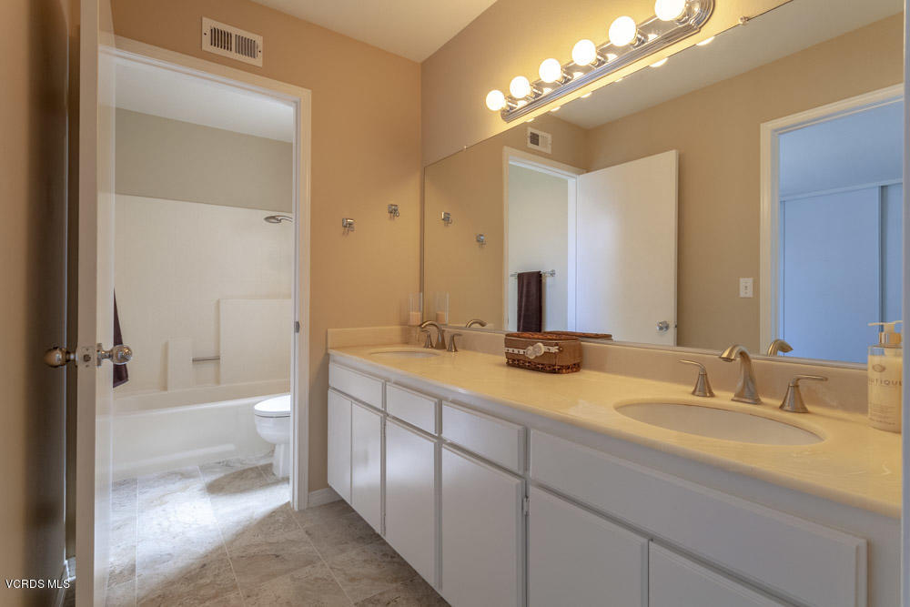 1990 Rory Lane, Unit 3 Simi Valley, CA 93063 - Photo 17 of 22 a bathroom with a sink double vanity granite tub and a mirror